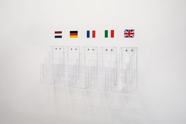 (13.32 15.10.2019, Venice),&nbsp;multi-pocket acrylic literature holders, flag stickers, dimensions variable, 2022.